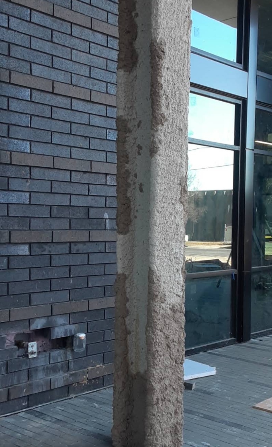 Spray-applied fireproofing on a structural steel column at a commercial building